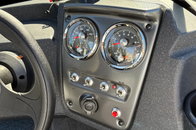 Slide: The Image of Dashboard of 2027 Tracker Pro Guide V-16 SC boat with gauges and controls. - 24