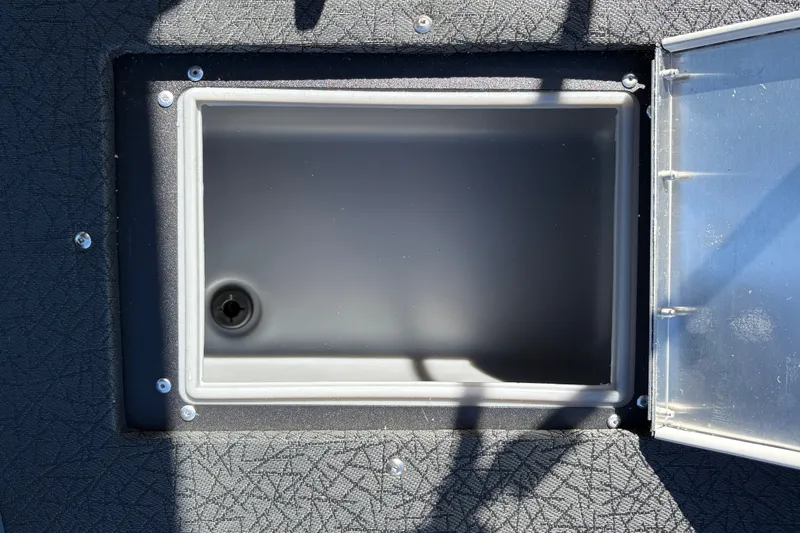 Slide: The Image of Open storage compartment on 2027 Tracker Pro Guide V-16 SC boat. - 26