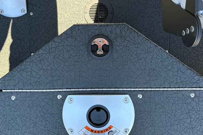Slide: The Image of 2027 Tracker Pro Guide V-16 SC boat deck with textured surface and metal fittings. - 27