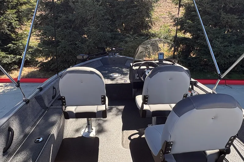 Slide: The Image of 2027 Tracker Pro Guide V-16 SC boat interior with seating and steering console. - 19