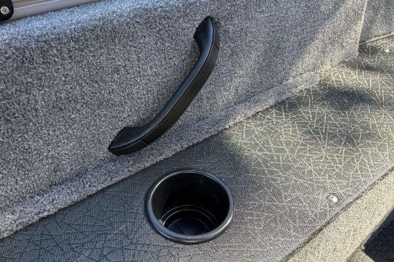 Slide: The Image of 2027 Tracker Pro Guide V-16 SC interior with cup holder and textured flooring. - 37