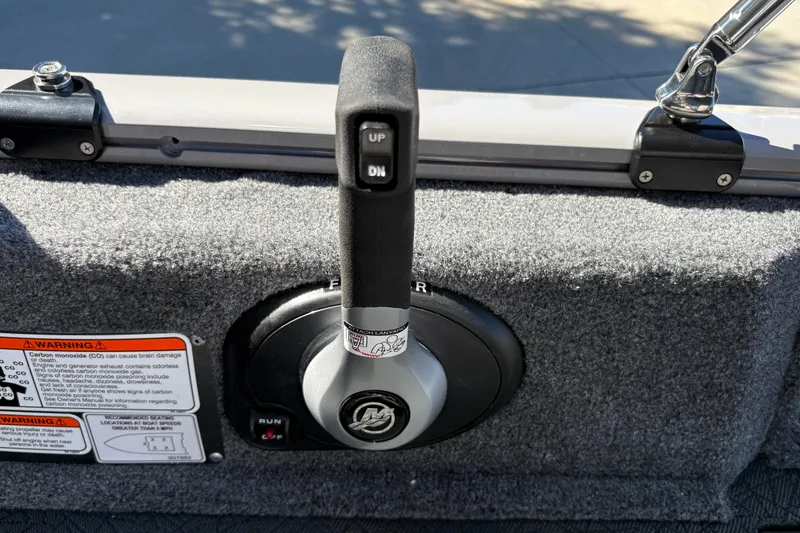 Slide: The Image of Throttle control lever on 2027 Tracker Pro Guide V-16 SC boat, with warning labels visible. - 34