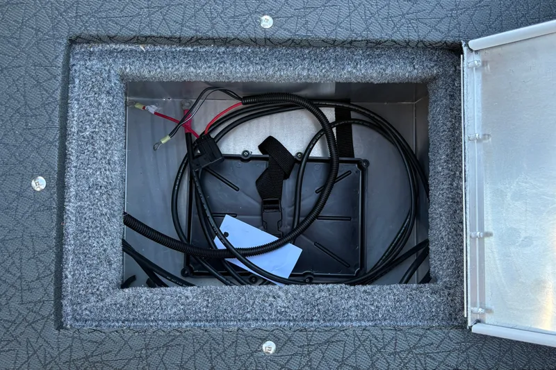Slide: The Image of Storage compartment of 2027 Tracker Pro Guide V-16 SC boat with wiring and cables. - 29