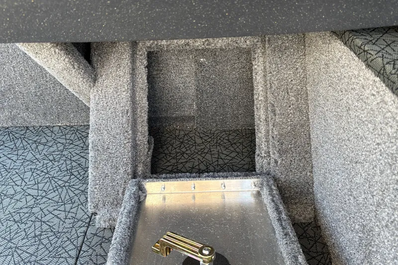 Slide: The Image of Interior view of 2027 Tracker Pro Guide V-16 SC boat, featuring carpeted storage compartment. - 36