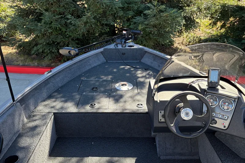 Slide: The Image of 2027 Tracker Pro Guide V-16 SC boat interior with steering wheel and control panel. - 23