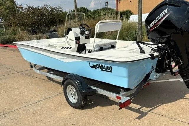 Slide: The Image of 2027 Mako Pro Skiff 17 CC boat on trailer with Mercury outboard motor. - 2