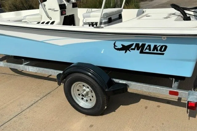 Slide: The Image of 2027 Mako Pro Skiff 17 CC boat on trailer, featuring light blue hull and logo. - 4