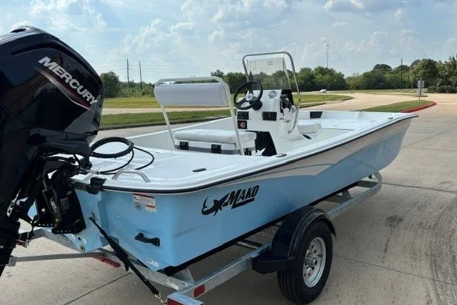 Slide: The Image of 2027 Mako Pro Skiff 17 CC boat on trailer, featuring a Mercury outboard motor. - 7