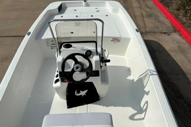 Slide: The Image of 2027 Mako Pro Skiff 17 CC boat interior with steering console and seating. - 14