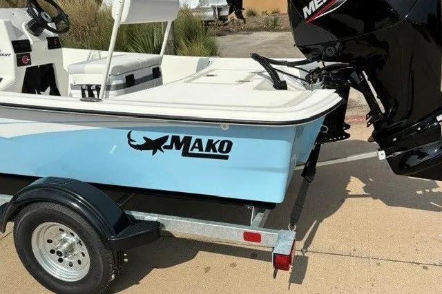 Slide: The Image of 2027 Mako Pro Skiff 17 CC boat on trailer, featuring sleek design and powerful engine. - 13