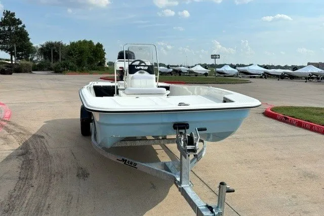 Slide: The Image of 2027 Mako Pro Skiff 17 CC boat on trailer in parking lot, clear sky background. - 5