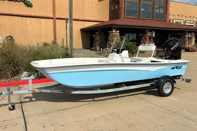 The Image of 2027 Mako Pro Skiff 17 CC boat on trailer, parked outside a building. - 0