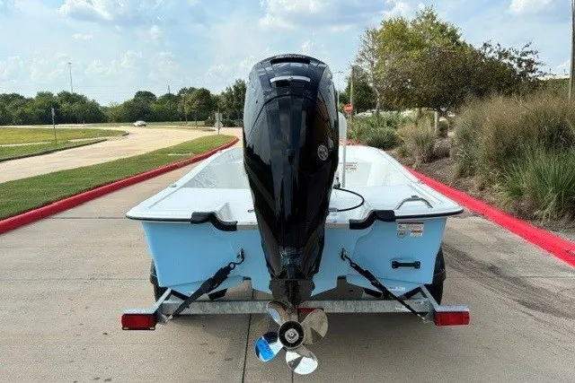 Slide: The Image of 2027 Mako Pro Skiff 17 CC boat on trailer, rear view with outboard motor. - 16