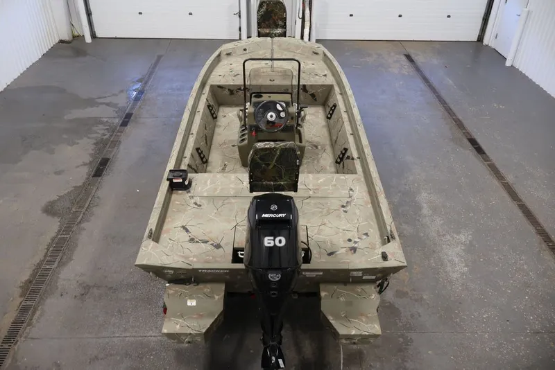 Slide: The Image of 2024 Tracker Grizzly 1860 MVX CC boat with Mercury 60 engine in a garage. - 20
