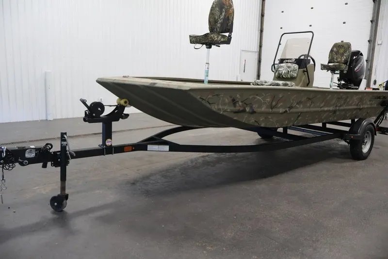Slide: The Image of 2024 Tracker Grizzly 1860 MVX CC boat on trailer in indoor setting. - 33