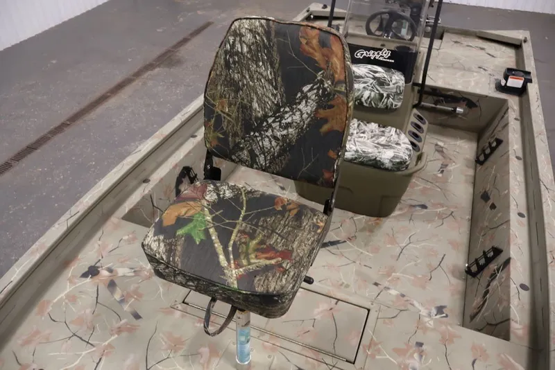 Slide: The Image of 2024 Tracker Grizzly 1860 MVX CC boat with camouflage seating and interior design. - 22