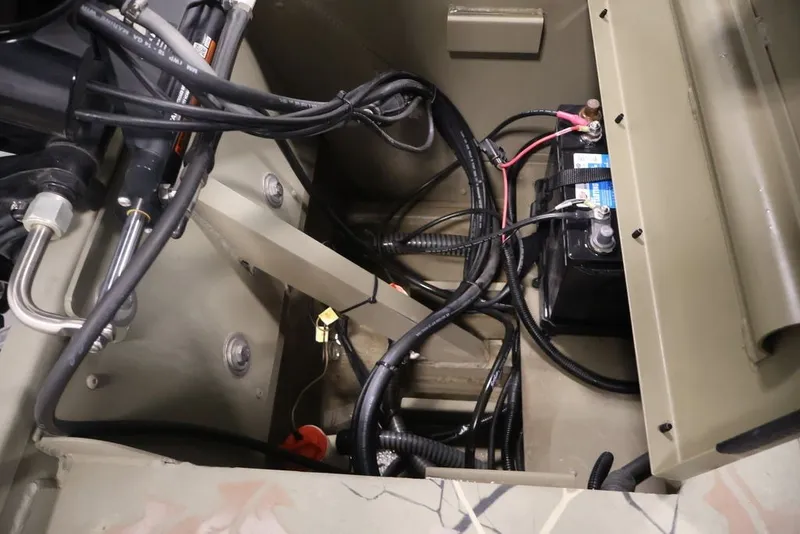 Slide: The Image of 2024 Tracker Grizzly 1860 MVX CC boat interior showing battery and wiring setup. - 31