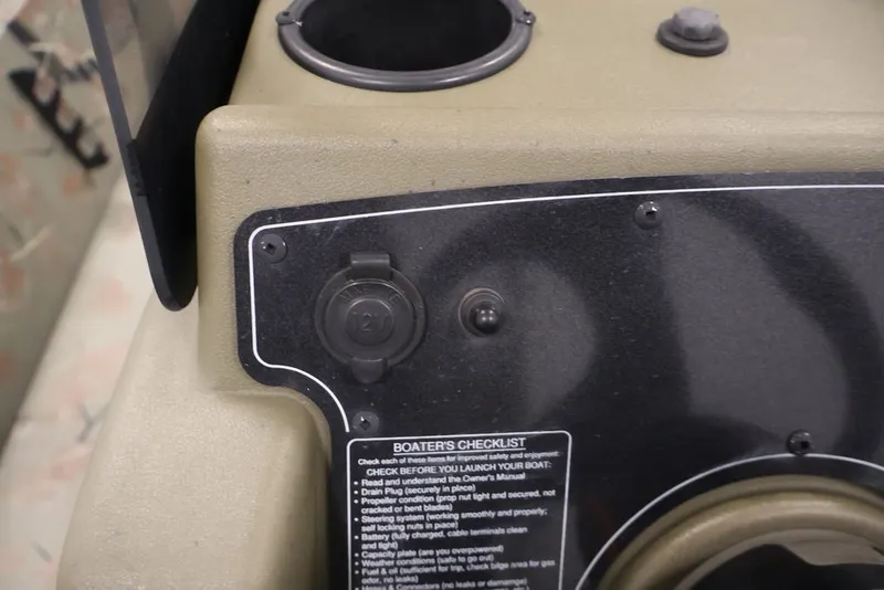 Slide: The Image of 2024 Tracker Grizzly 1860 MVX CC dashboard with boater's checklist and controls. - 27