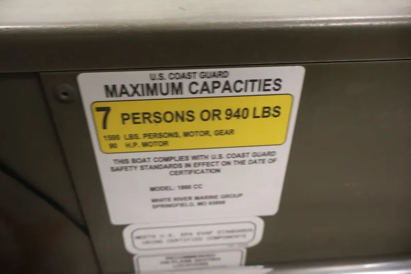 Slide: The Image of 2024 Tracker Grizzly 1860 MVX CC boat capacity label: 7 persons or 940 lbs. - 18