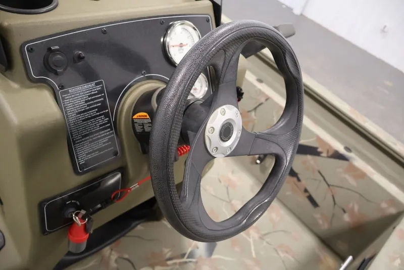Slide: The Image of 2024 Tracker Grizzly 1860 MVX CC steering wheel and dashboard close-up. - 23