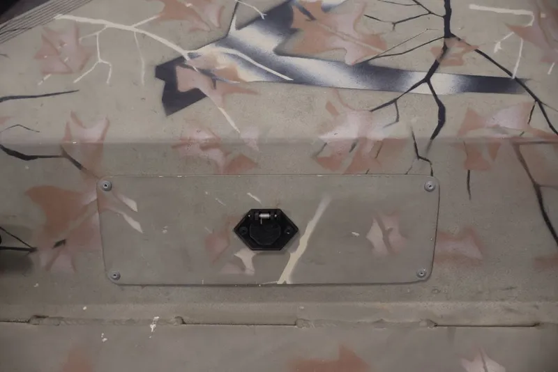 Slide: The Image of 2024 Tracker Grizzly 1860 MVX CC boat with camouflage pattern and secure latch. - 25