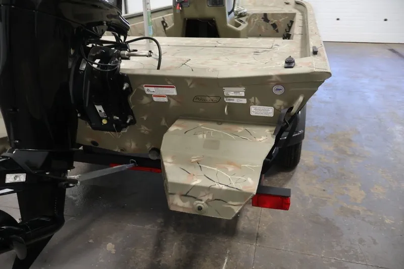 Slide: The Image of 2024 Tracker Grizzly 1860 MVX CC boat with camouflage design and outboard motor. - 35