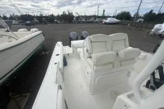 Slide: The Image of 2017 Sea Hunt Gamefish 27 boat with dual engines in a marina setting. - 8