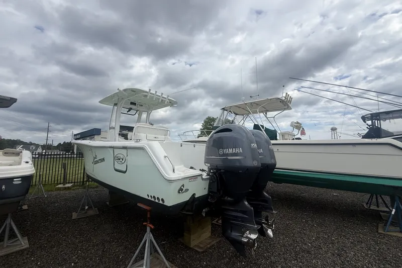 Slide: The Image of 2017 Sea Hunt Gamefish 27 boat with Yamaha engines on display under cloudy skies. - 4