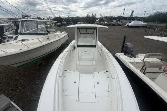 Slide: The Image of 2017 Sea Hunt Gamefish 27 boat docked among other vessels under cloudy skies. - 9