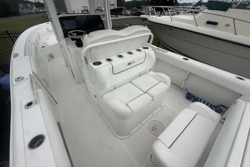 Slide: The Image of 2017 Sea Hunt Gamefish 27 boat interior with white seating and control panel. - 7