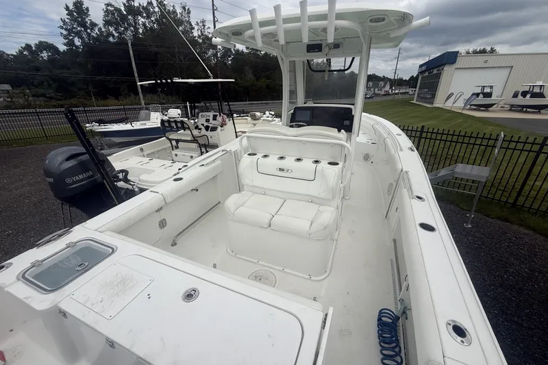 Slide: The Image of 2017 Sea Hunt Gamefish 27 boat with Yamaha engine, white interior, and spacious deck. - 6