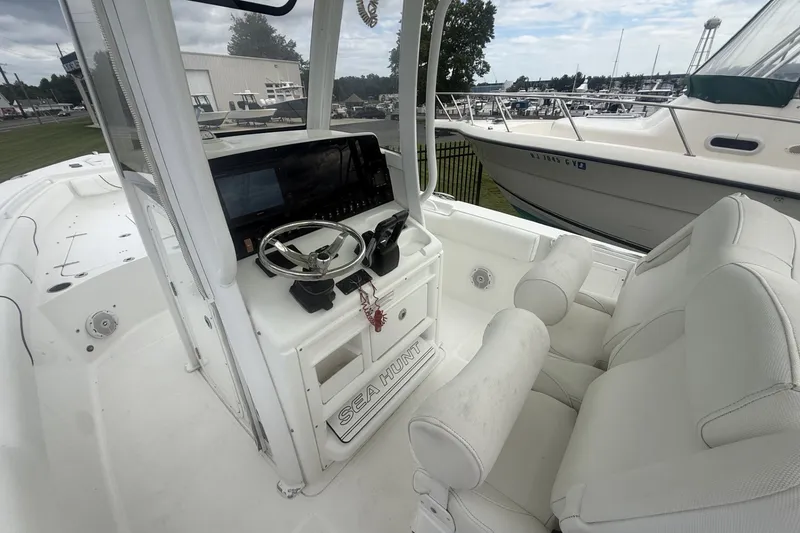 Slide: The Image of 2017 Sea Hunt Gamefish 27 boat interior with steering console and seating. - 10