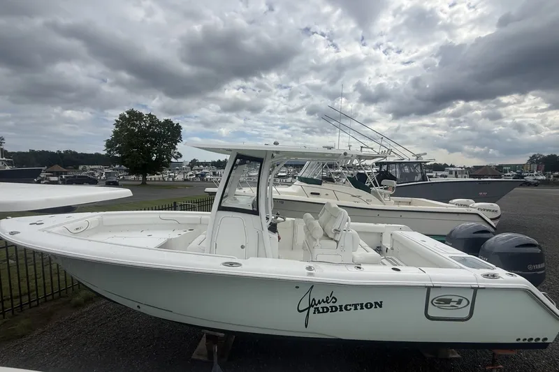 The Image of 2017 Sea Hunt Gamefish 27 boat on display under cloudy skies. - 1
