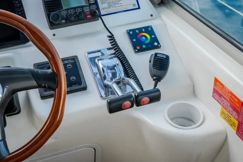 Slide: The Image of Control panel of a 1997 Sea Ray Sundancer 400 boat with steering wheel and radio. - 25