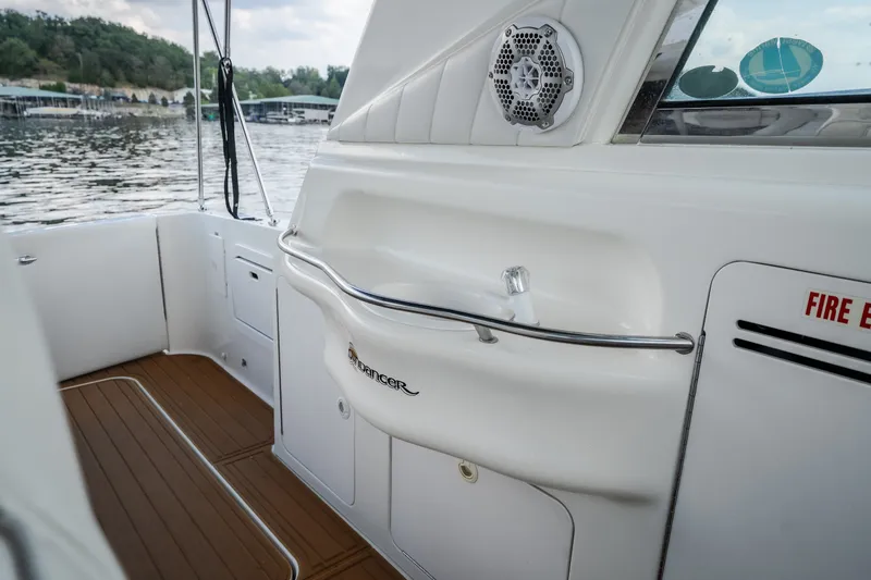 Slide: The Image of 1997 Sea Ray Sundancer 400 boat interior with white seating and wood flooring. - 14