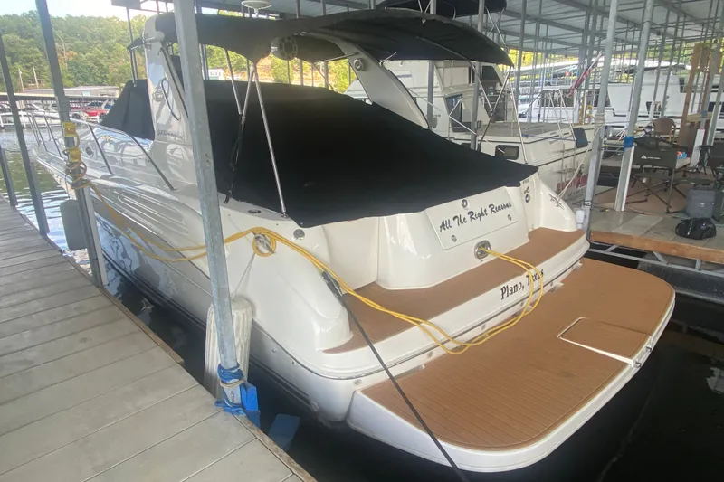 Slide: The Image of 1997 Sea Ray 40 Sundancer docked, covered, with teak swim platform. - 42