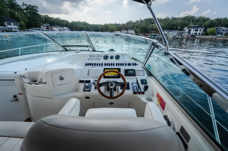 Slide: The Image of Cockpit view of a 1997 Sea Ray Sundancer 400 yacht on a serene lake. - 11