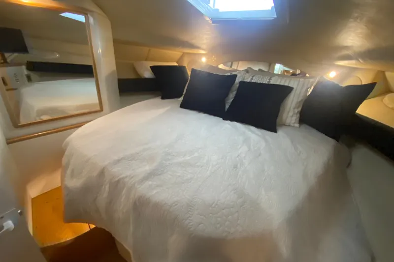 Slide: The Image of Interior cabin of 1997 Sea Ray 40 Sundancer with cozy bed and pillows. - 19