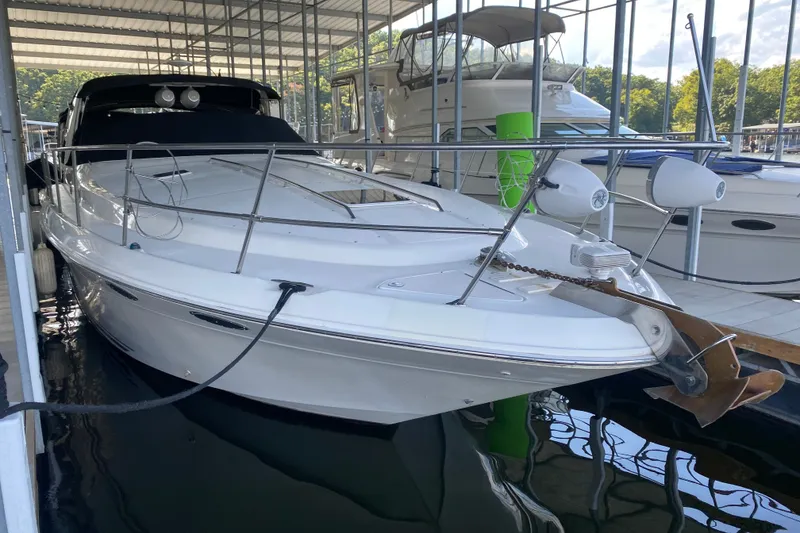 Slide: The Image of 1997 Sea Ray 40 Sundancer yacht docked in a marina, front view. - 38