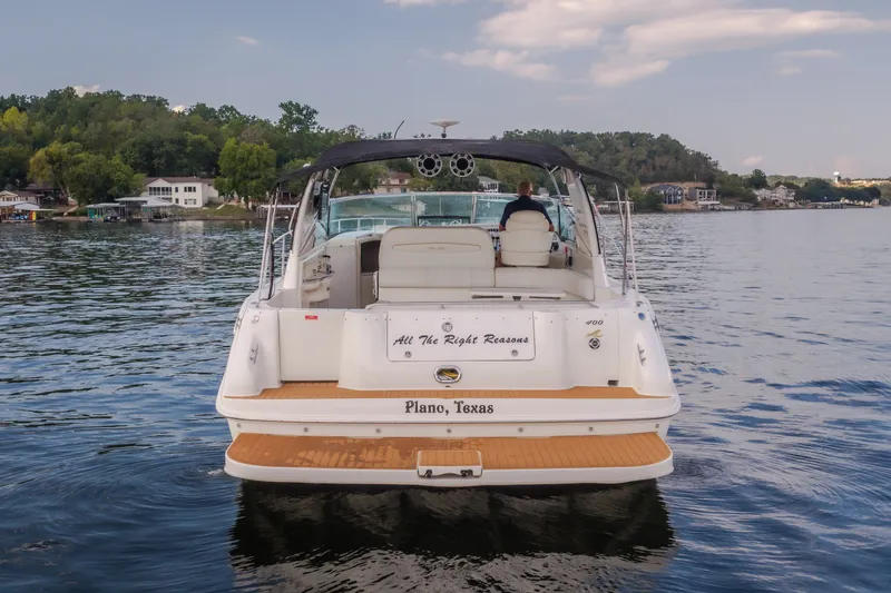 Slide: The Image of 1997 Sea Ray Sundancer 400 boat on a lake, rear view, with "Plano, Texas" inscription. - 6
