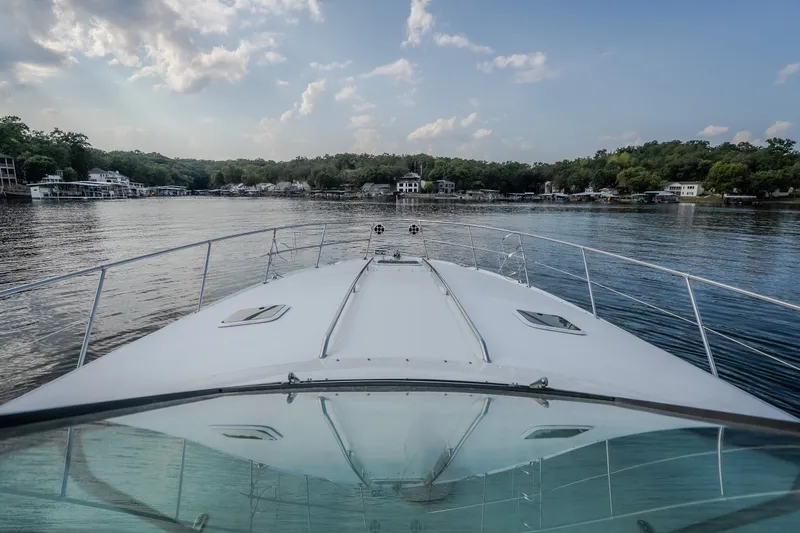 Slide: The Image of Bow view of 1997 Sea Ray Sundancer 400 cruising on a serene lake. - 61