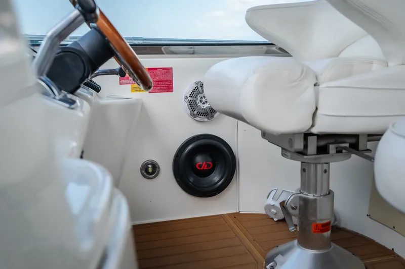 Slide: The Image of 1997 Sea Ray Sundancer 400 helm with white seating and audio system. - 8