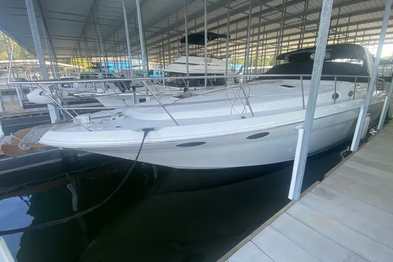 Slide: The Image of 1997 Sea Ray 40 Sundancer yacht docked in a covered marina. - 43