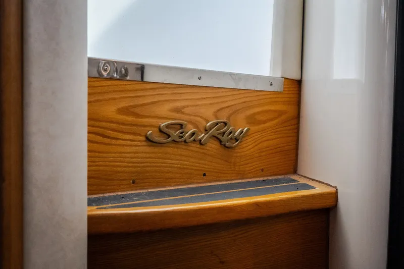 Slide: The Image of 1997 Sea Ray Sundancer 400 interior detail with wooden panel and logo. - 48
