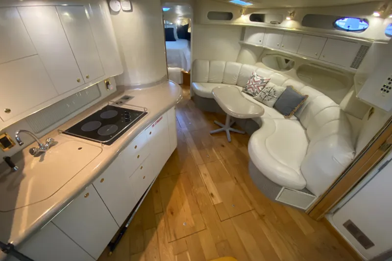 Slide: The Image of Luxurious interior of a 1997 Sea Ray 40 Sundancer yacht with kitchen and seating area. - 14