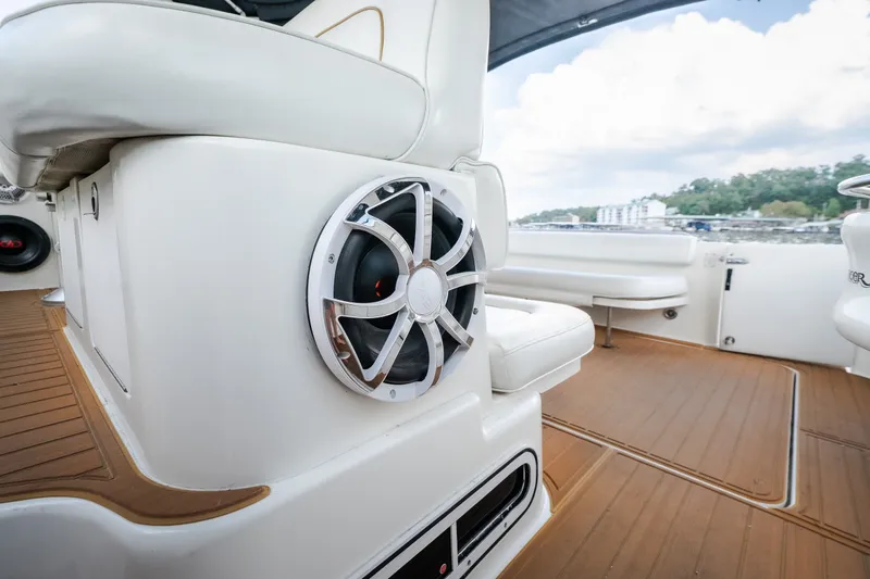 Slide: The Image of 1997 Sea Ray Sundancer 400 interior with speaker and white seating on teak flooring. - 15