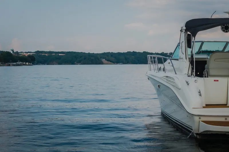 Slide: The Image of 1997 Sea Ray Sundancer 400 yacht on calm lake with distant shoreline. - 65