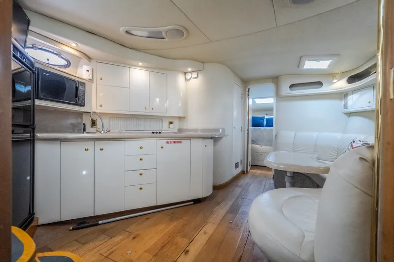 Slide: The Image of Interior of a 1997 Sea Ray Sundancer 400 yacht with modern kitchen and seating area. - 50