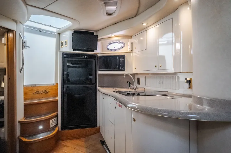 Slide: The Image of Interior of a 1997 Sea Ray Sundancer 400 yacht kitchen with modern amenities. - 59