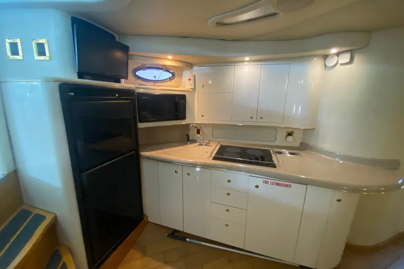 Slide: The Image of Luxurious 1997 Sea Ray 40 Sundancer yacht kitchen with modern appliances and sleek cabinetry. - 31